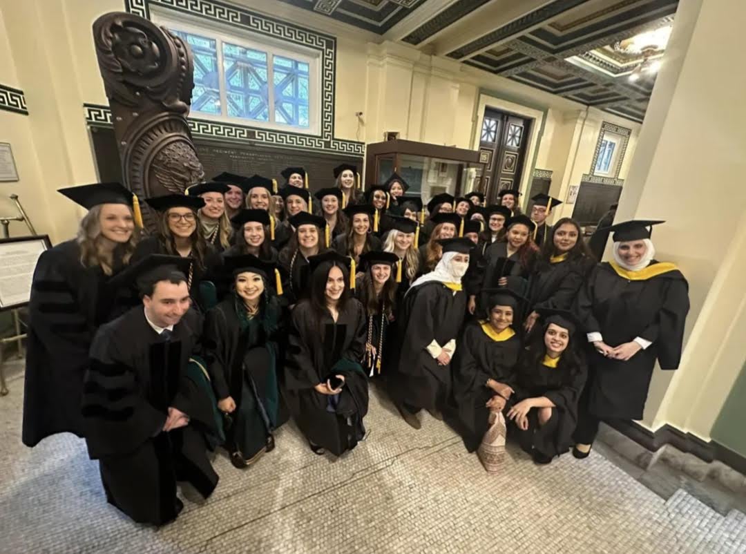 Group of graduates wearing cap & gown before graduation ceremony