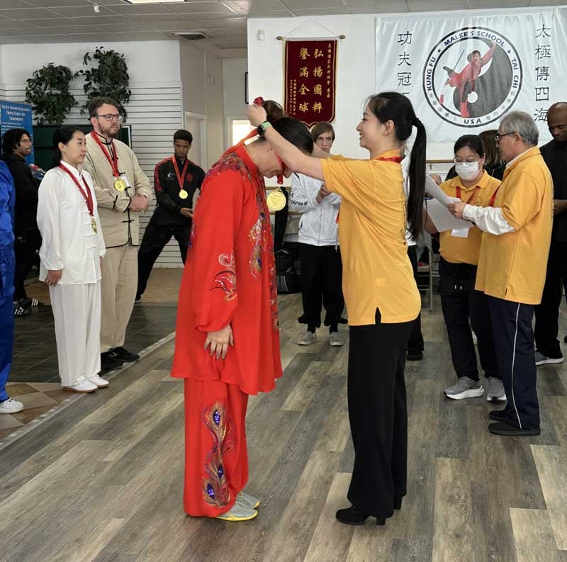 Last year at the U.S. A National Traditional Kungfu Team Trials, Wang served as a judge and awarded medals to the first place selected U.S. Traditional Wushu National Team member.