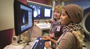Student with clinical instructor looking at images on a computer