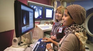 Student with clinical instructor looking at images on a computer