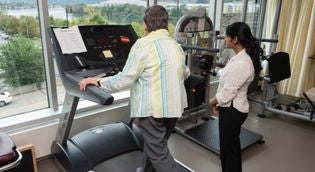 woman using a treadmill in a PT research center
