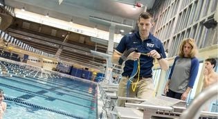 sports scientist using force measuring device in a pool