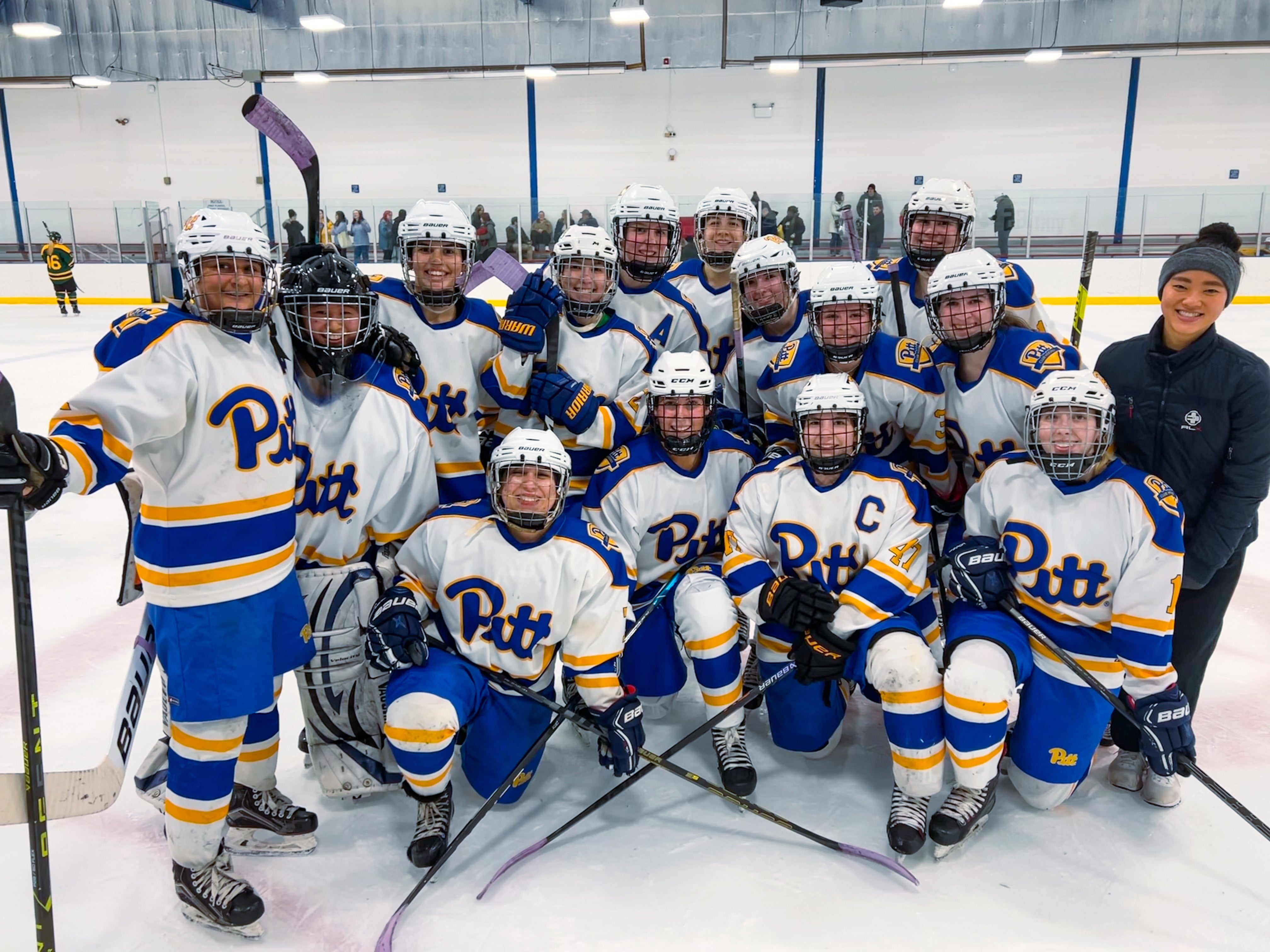 Flynn (far right) and the Pitt women’s ice hockey team celebrating a 4-3 overtime win against Brockport