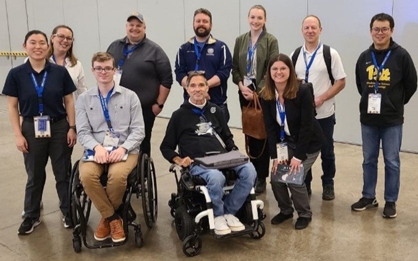 Design faculty Professor David Brienza (back row, second from right) and Todd Hargroder (front row, center) join students from the Masters in Rehabilitation Technology at ISS.