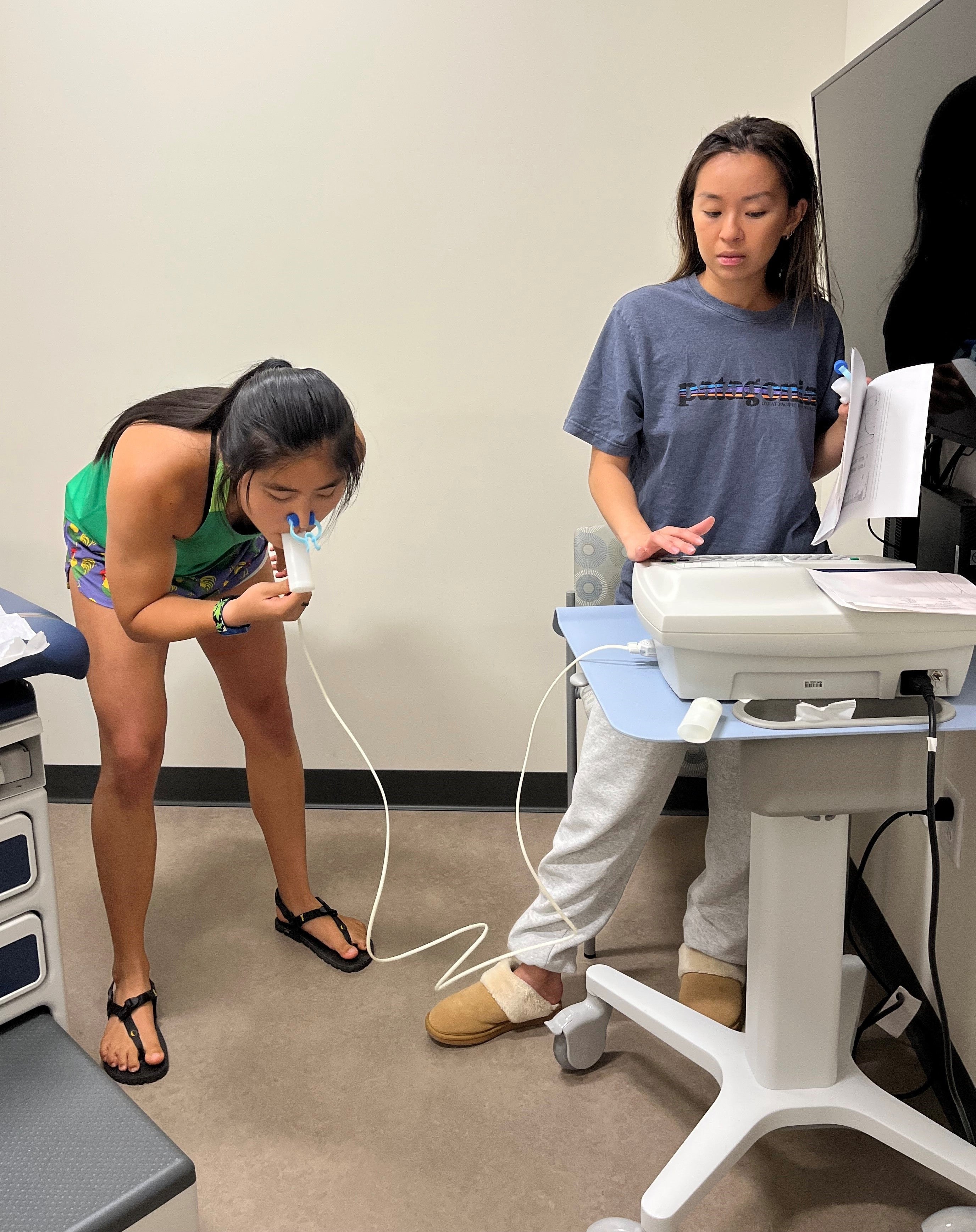 Angie Wu (left) with fellow PAS student Tracy Vu measuring spirometry