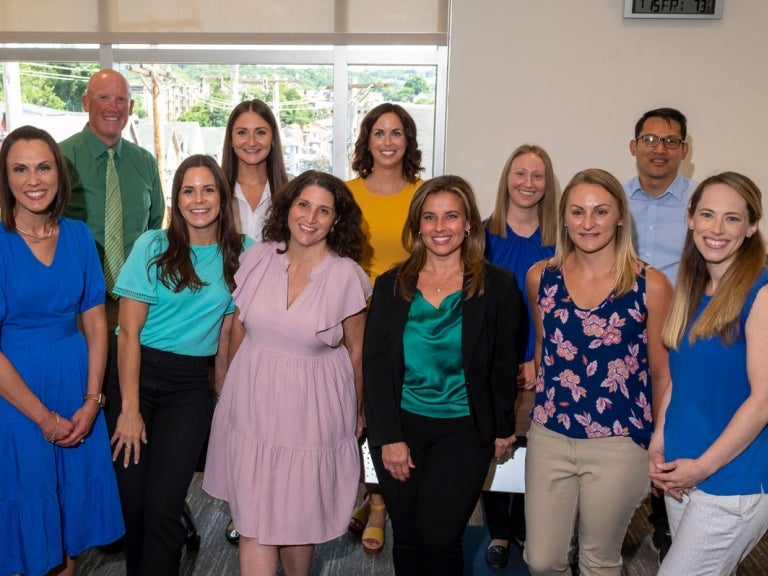 Recent Pitt DPAS graduates Cynthia Likar (front row, third from right) and Kelly Nicholas (front row, far right) with other DPAS students and graduates