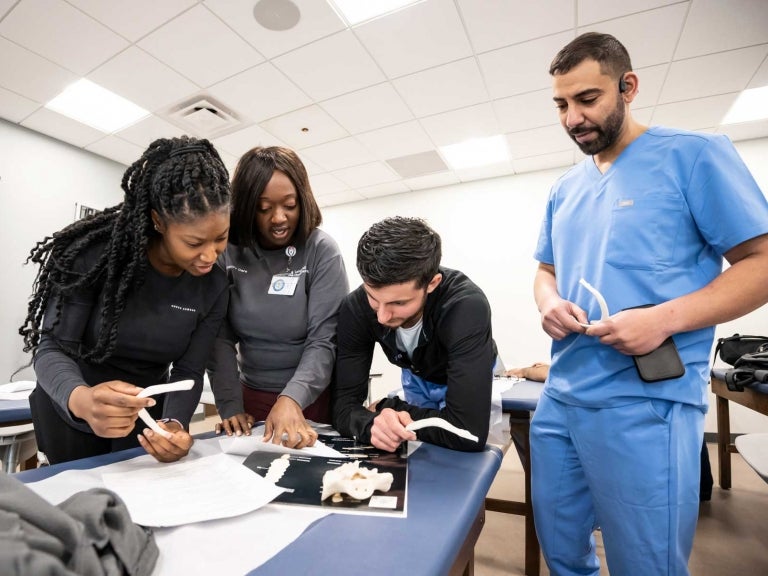 Pitt PA Studies Hybrid students practicing clinical skills at their in-person immersion session.