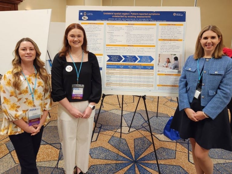 Pitt OT student and faculty standing in front of conference poster