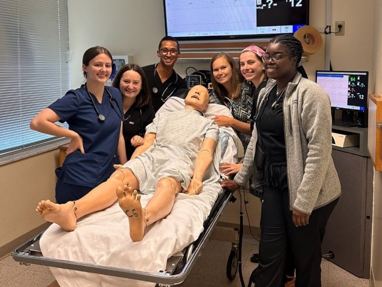 Julie Dubis (third in from the right) with SHRS Physician Assistant Studies (PAS) students in a simulation room