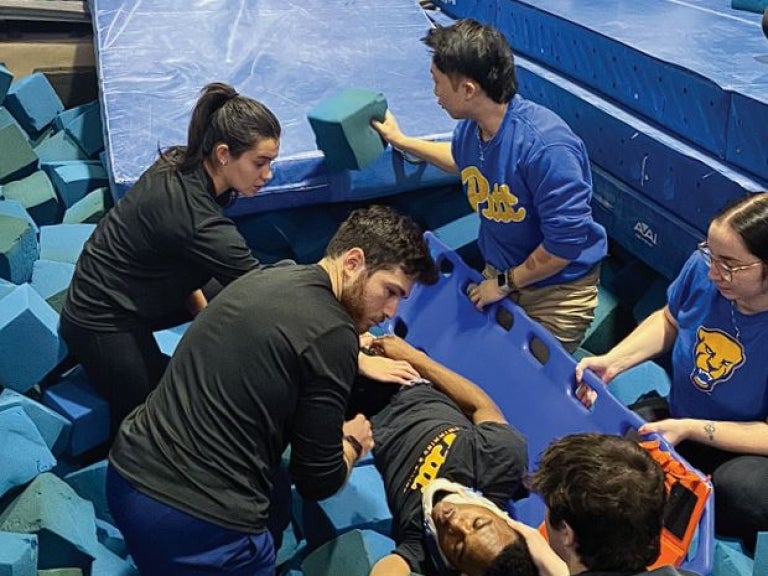 AT students routinely practice spine board extrication from the pool, the gymnastics pit and on the ice