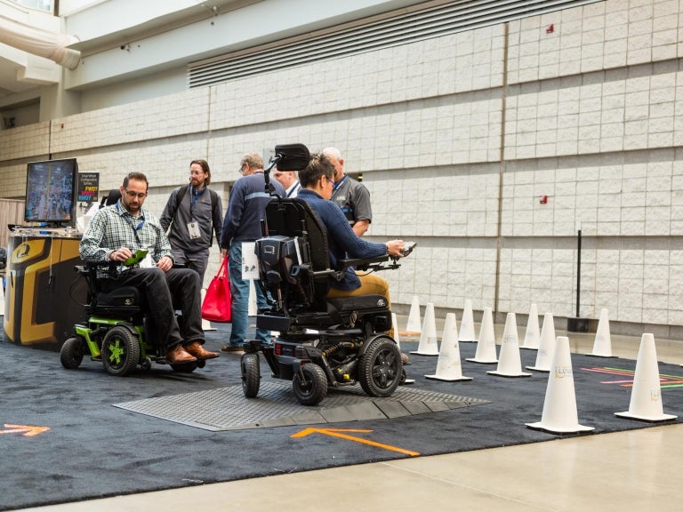 people testing wheelchairs at ISS 2019