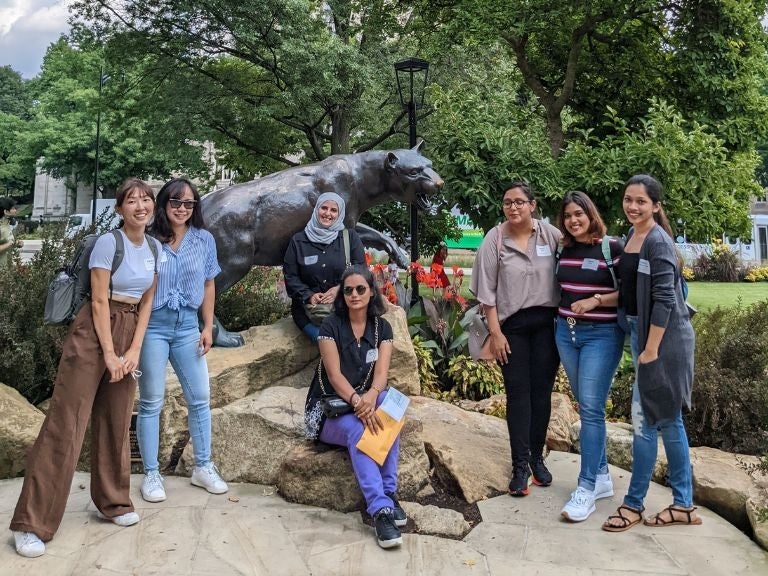 7 new students standing in front of the panther statue