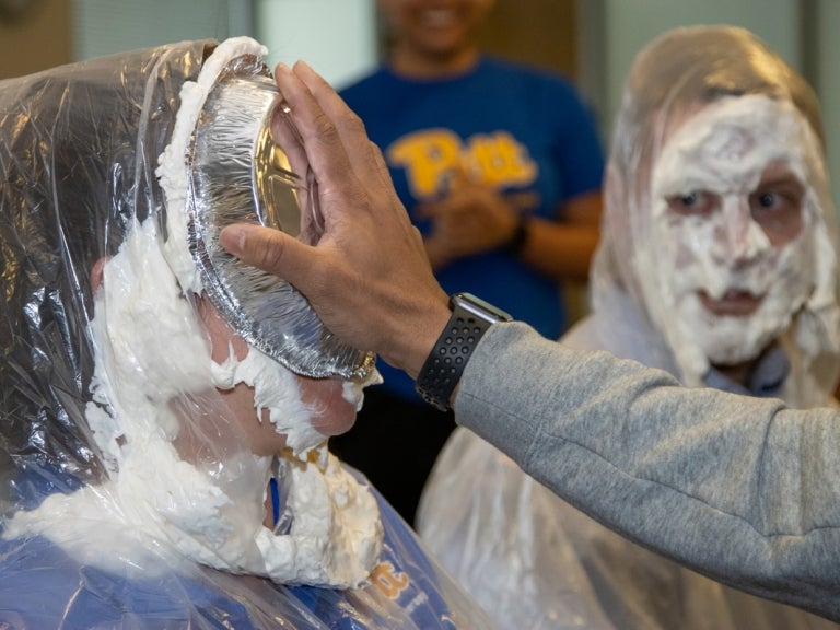 Department of Physical Therapy Assistant Professor Valerie Shuman getting “pied” while Assistant Professor Andrew Sprague looks on