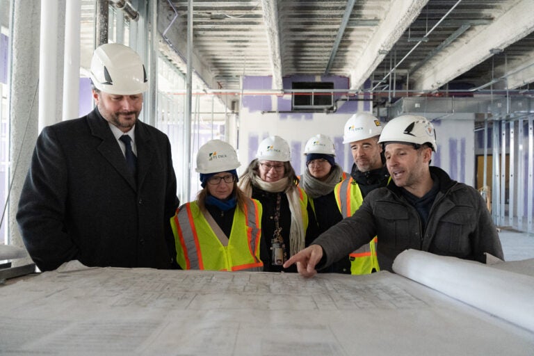 SHRS leadership with Facilities representatives reviewing the new building's floor plans.
