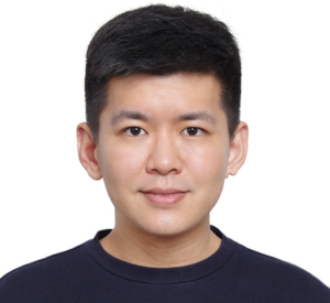 A man with short dark hair wearing a black shirt.