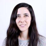 Woman with dark hair wearing a gray sweater.