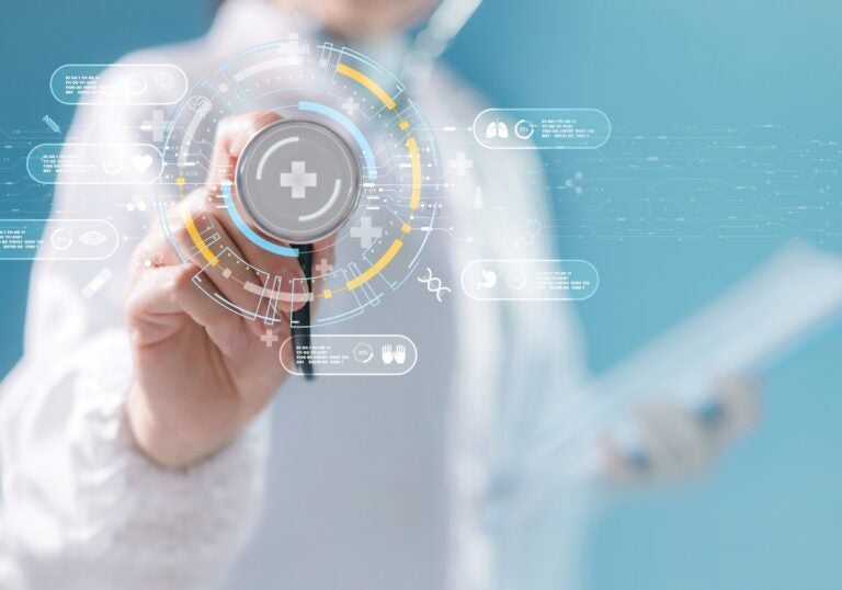 A graphic showing a hand pointing to a dial with health care graphic circling around it